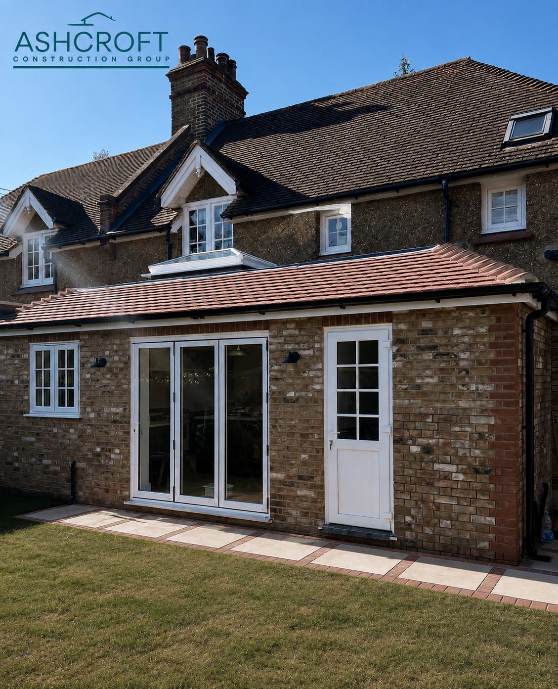 Completed brick rear extension with French doors, branded Ashcroft Construction Group
