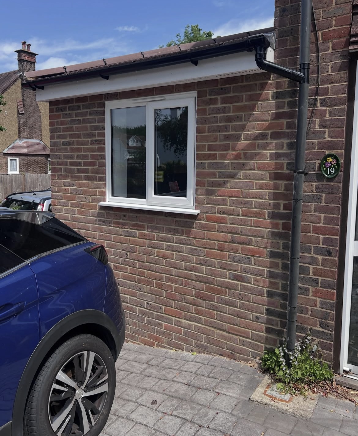 Brick side extension beside a driveway after completion