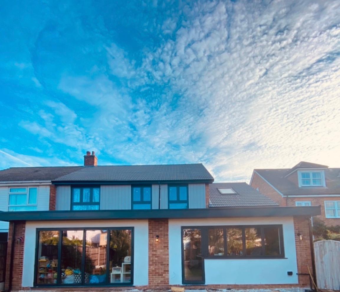 Completed two-storey rear house extension with dark-framed glazing