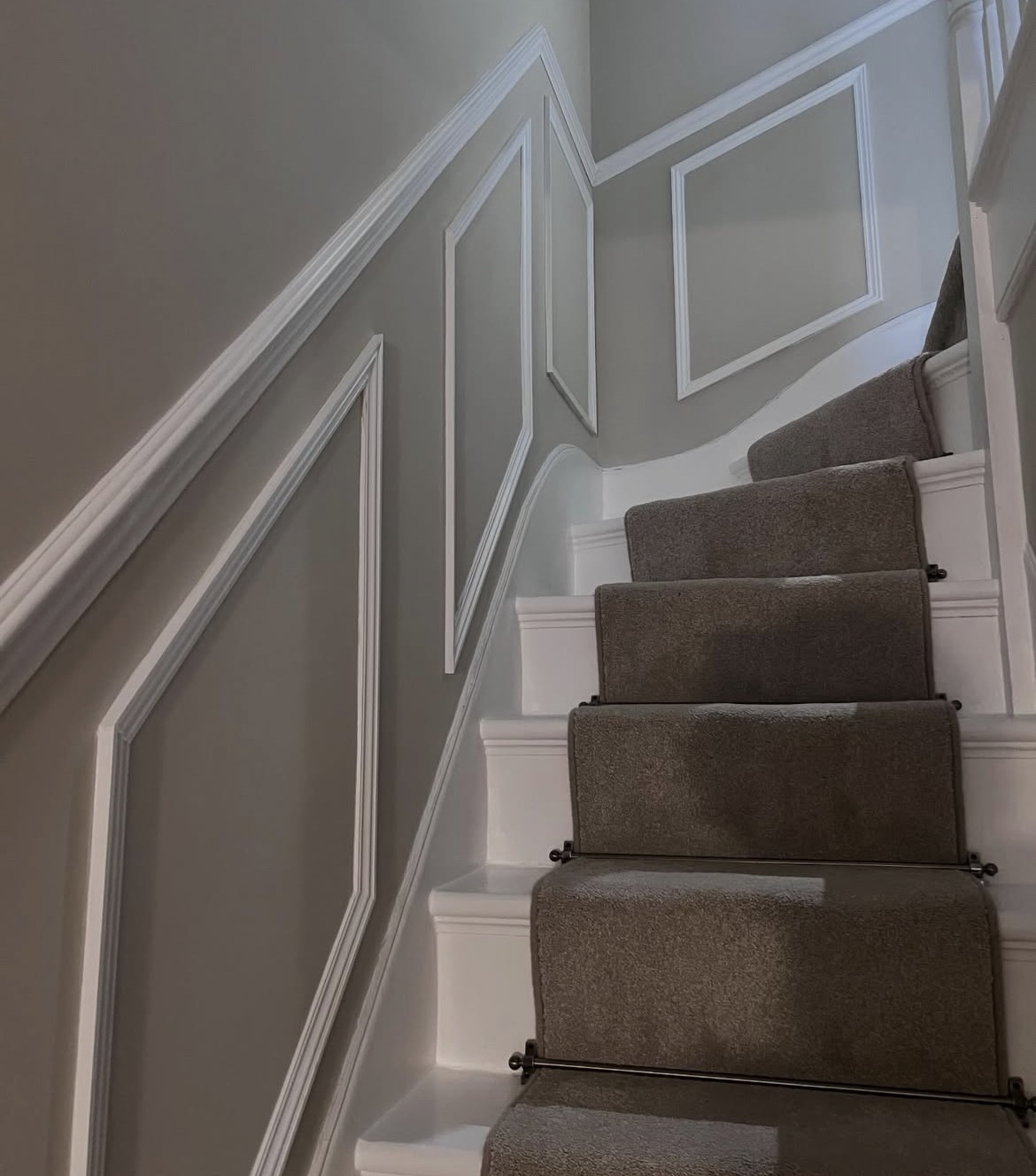 Renovated staircase with decorative wall panelling and new mouldings