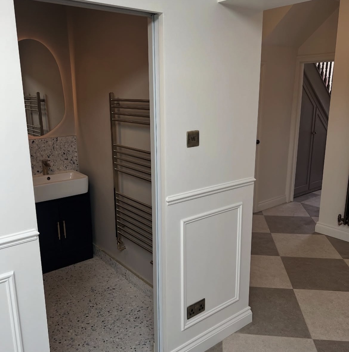 Extension hallway detail with panelling, cloakroom doorway and tiled floor