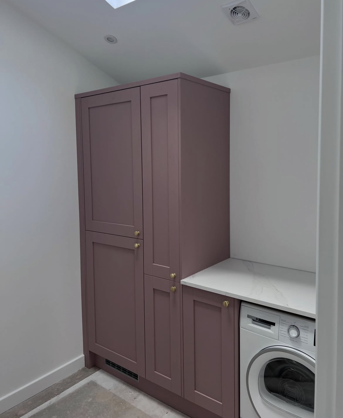 Fitted utility cupboards and worktop inside a completed side extension