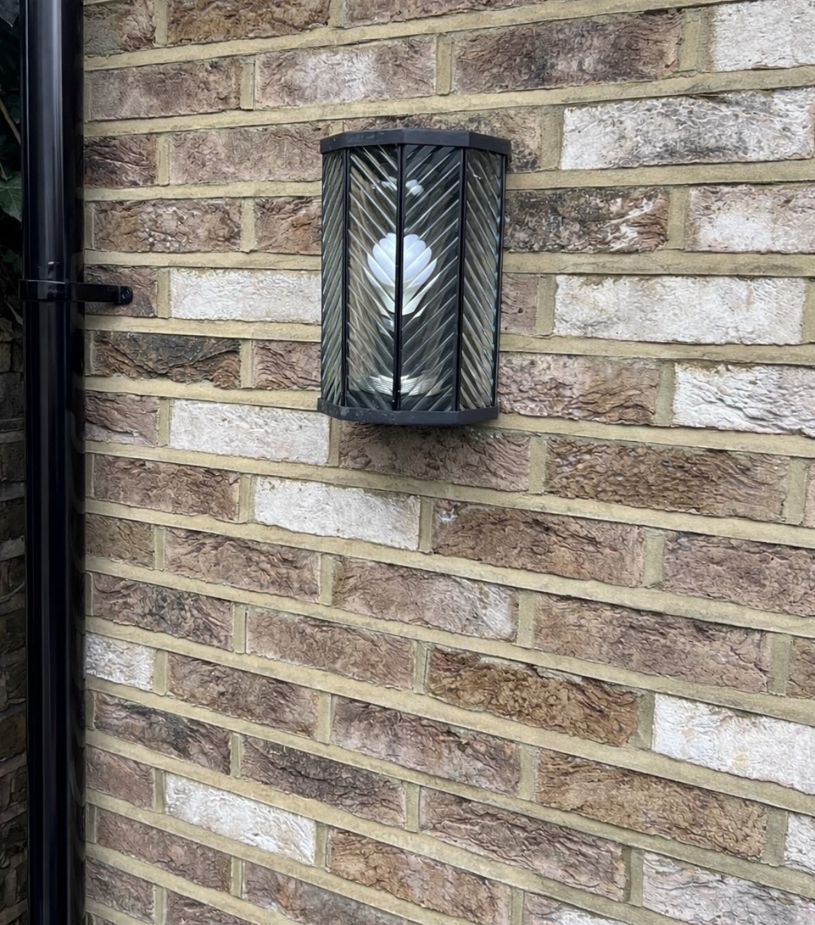 Exterior wall light and decorative brickwork detail on a completed house renovation
