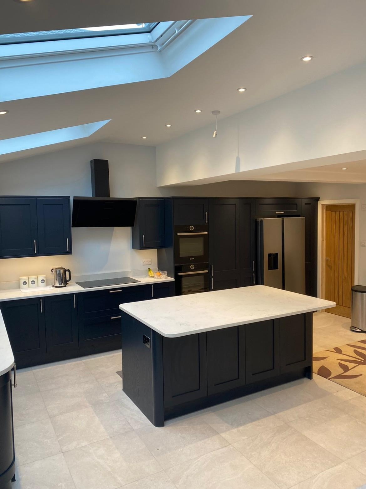 Large kitchen extension interior with island, rooflights and integrated appliances