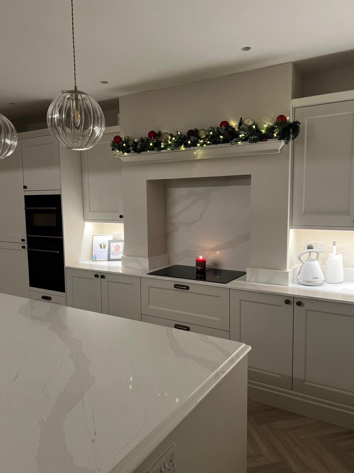 Refurbished kitchen with island and integrated appliances in a family home