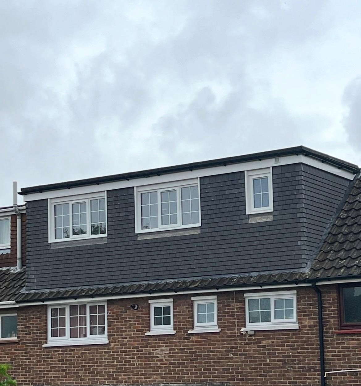 Completed rear dormer loft conversion with dark cladding and new windows