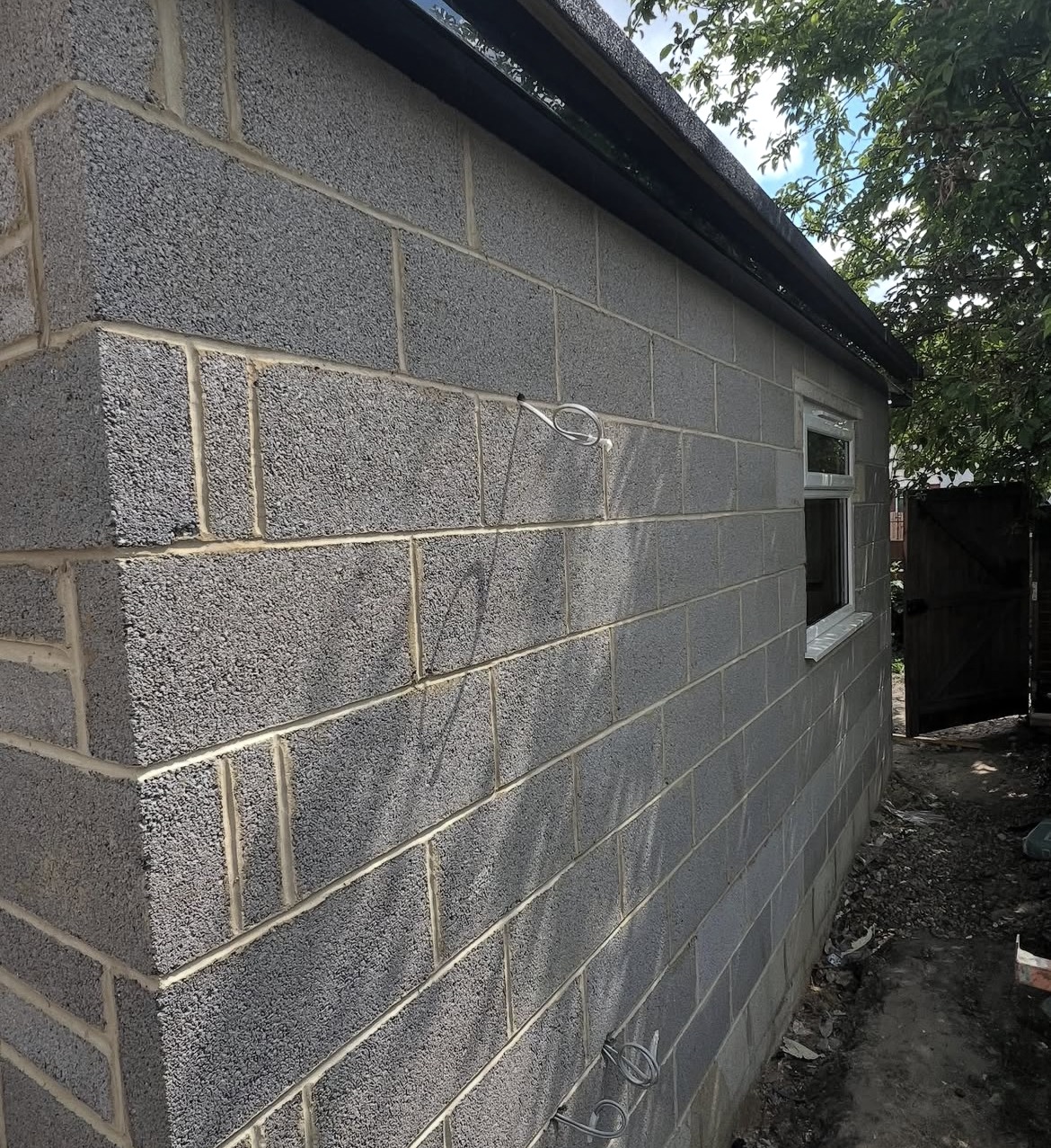 Blockwork and electrical cabling during garden outbuilding construction