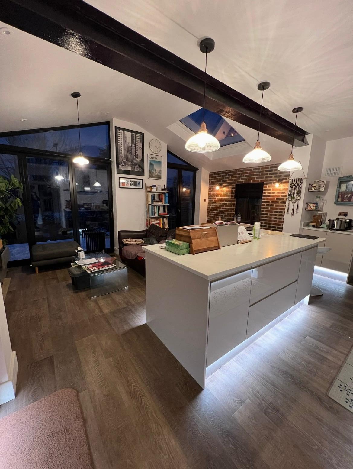 Open-plan kitchen extension with island, pendant lighting and exposed structural beam