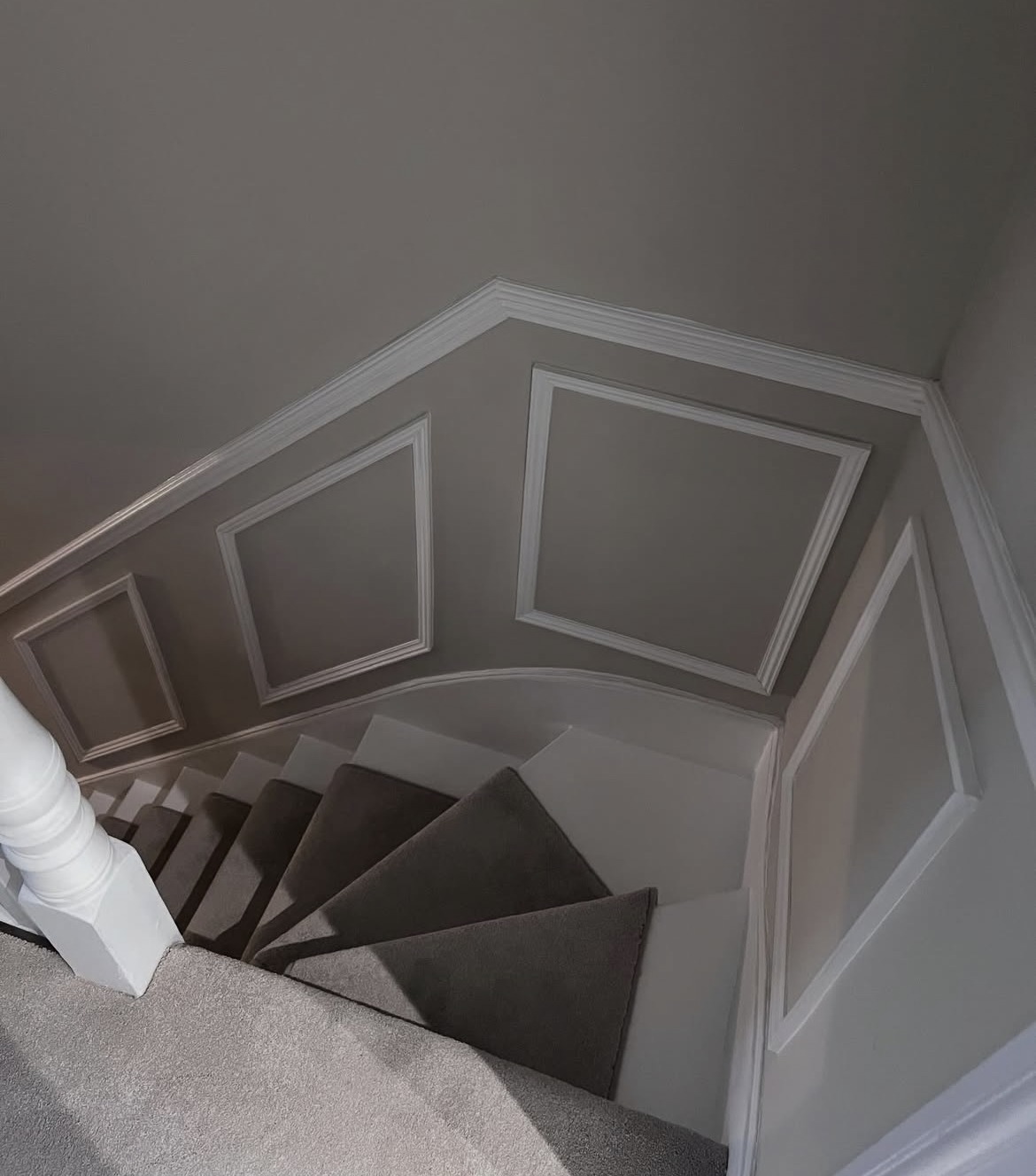 Staircase and landing after renovation, with panelling and fresh decoration