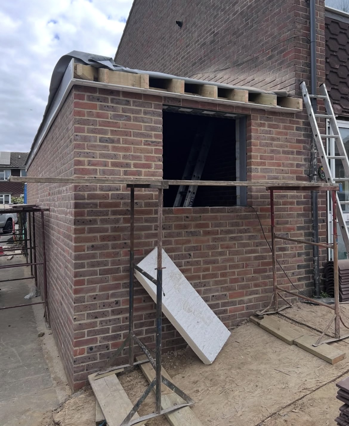 Side extension in Sidcup during construction, with new brickwork and roof timbers