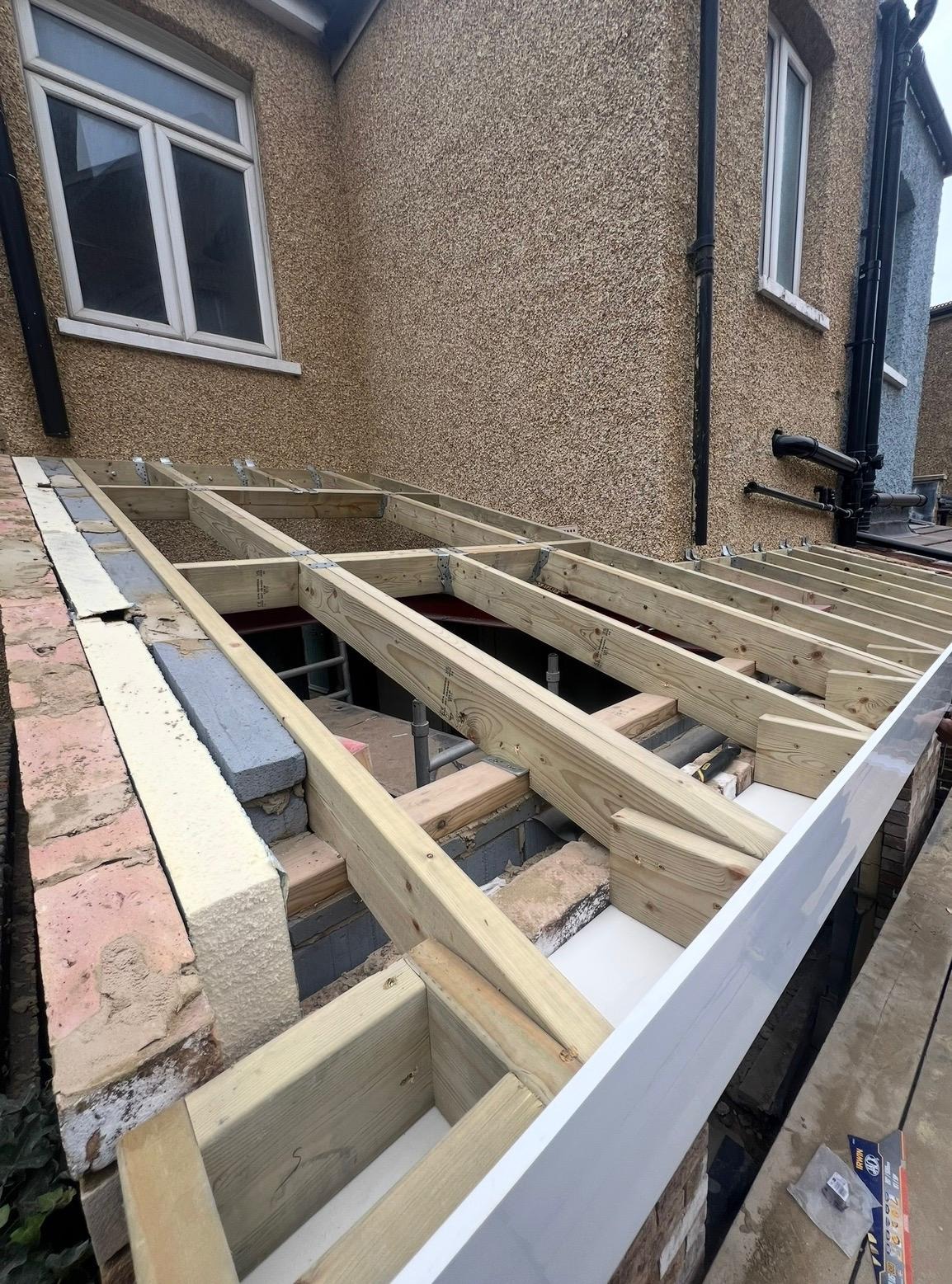 Timber joists and framing being installed on a house extension